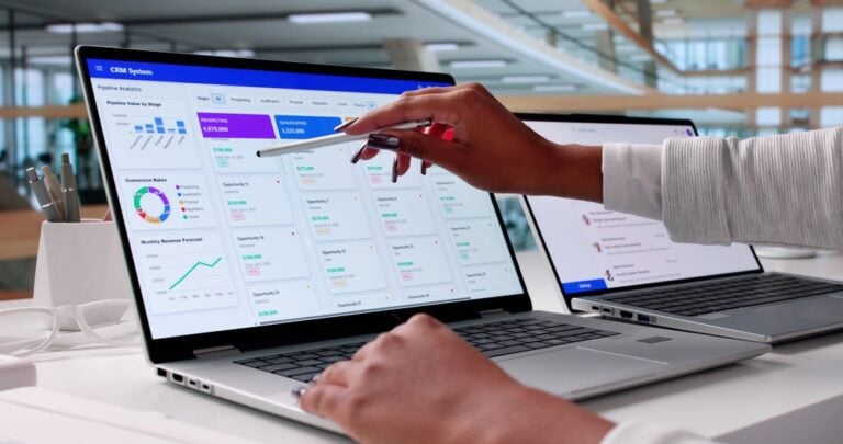 Community Care Systems - image of a woman's hand using a stylus on a laptop screen