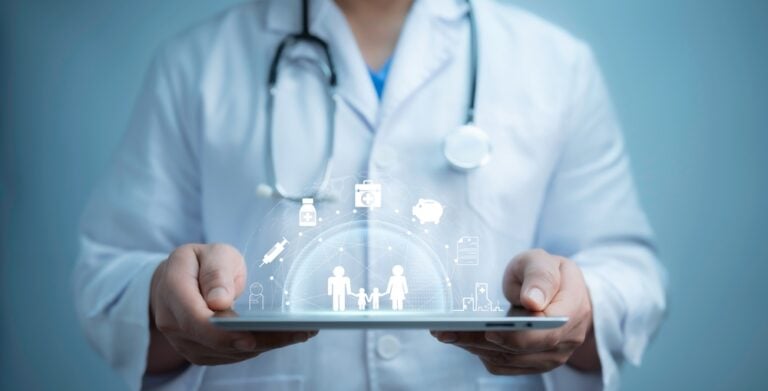 Community Health Data - image of a doctor holding a tablet with virtual health care icons