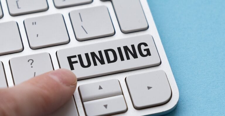 Nonprofit funding - image of a finger pressing a button that says "funding" on a keyboard