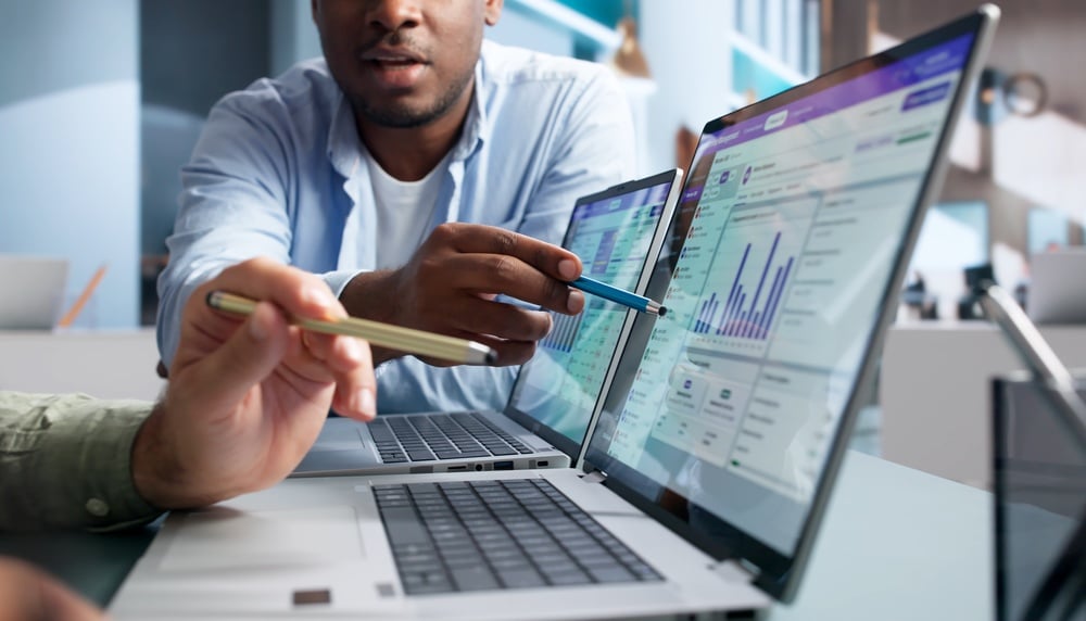image of two workers looking at gran management software for nonprofits.